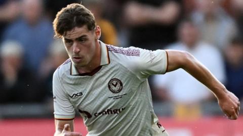 Alfie Merritt runs with the ball for Newport County against Roma