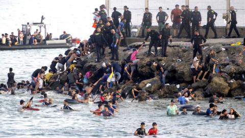 migrants swimming into Ceuta