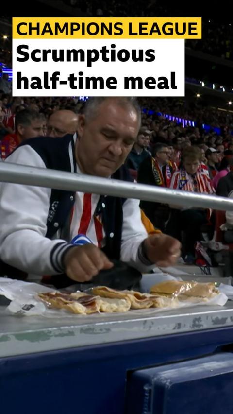 Atletico Madrid fan making a sandwich 