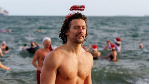 People taking part in the annual Christmas Eve swim at Helen's Bay, Co. Down, in aid of local charities.