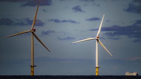 A ship passing wind turbines at RWE's Gwynt y Mor, the world's 2nd largest offshore wind farm located eight miles offshore in Liverpool Bay, off the coast of North Wales.