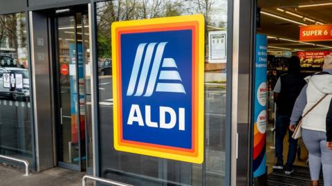An Aldi logo on the outside of an Aldi supermarket in the UK