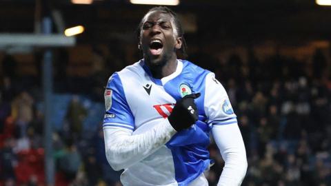 Moussa Baradji celebrates after scoring for Blackburn Rovers, running while grabbing his shirt on his chest