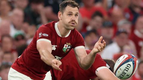 Tomos WIlliams passes the ball for the Lions