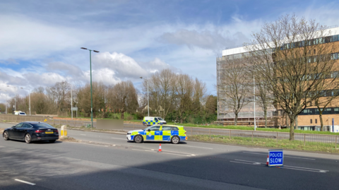 An image of police at the scene of a crash on the A52