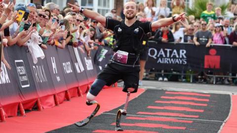 Billy Monger crosses the line at the ironman race in Weymouth