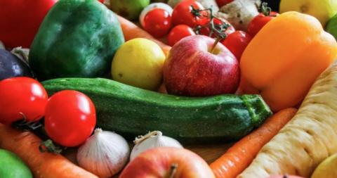 A picture of fruit and vegetables, including tomatos, apples and carrots.