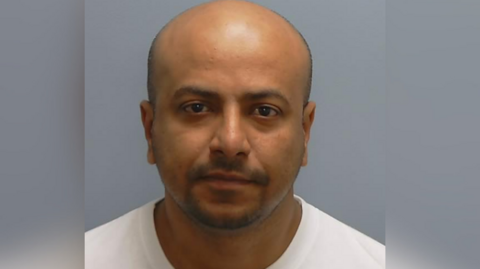 A handout photo issued by Hampshire Police of Anwar Ashraf. He is looking at the camera and wearing a white shirt.
