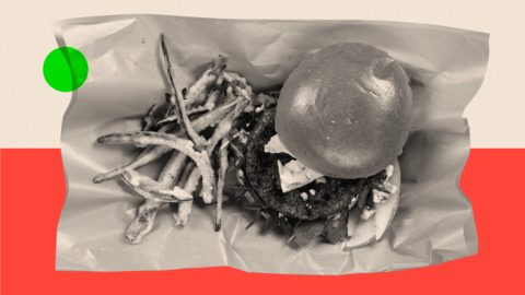 A treated image showing a burger in black and white on a red background

