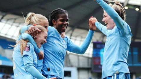 Manchester City celebrate scoring a goal last season