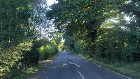 Google maps image of the A46 country road. An arrow can be seen in the middle of the road pointing slightly left. 