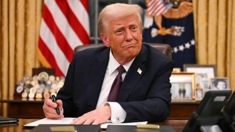 US President Donald Trump signs executive orders in the Oval Office of the White House in Washington, DC, on 20 January, 2025. 