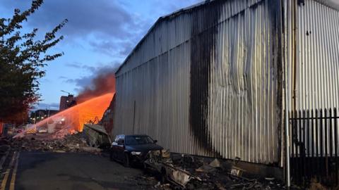 A fire crew tackles a fire at an industrial unit