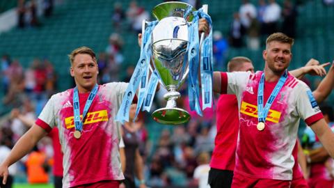 Alex Dombrandt, left, and Stephan Lewies lift the Premiership trophy aloft