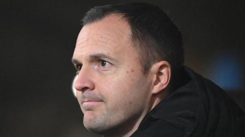 Birmingham City boss Chris Davies looking bit pensive on bench, head shot, wearing warm dark jacket