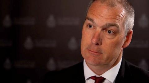 Det Supt Phill Gray - his face against a dark background