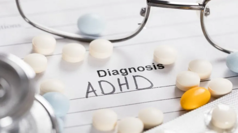 A doctor's notepad with the words "Diagnosis ADHD" written on it