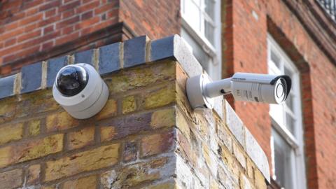 Two CCTV cameras fitted outside a building.