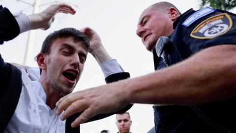 Ultra-Orthodox Jewish man shouts in front of a policeman at a protest following the Israeli Supreme Court ruling that requires the state to begin drafting ultra-Orthodox Jewish seminary students to the military (27/06/24)