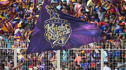 A Kolkata Knight Riders fan waves a big flag