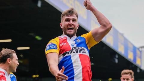 Josh Rourke celebrates scoring a try for London