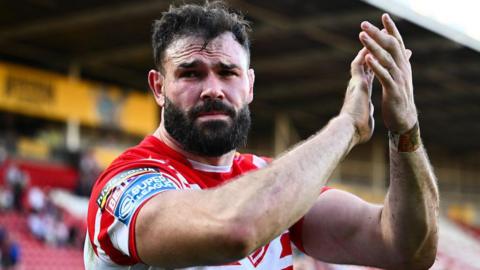 St Helens prop Alex Walmlsey applauds the fans