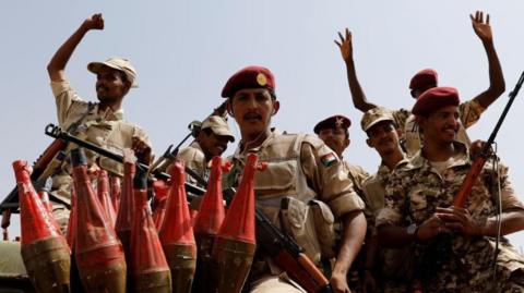 Sudan's paramilitary Rapid Support Forces (RSF) soldiers greet people as they secure a site where their attends a meeting in Khartoum in June 2019.
