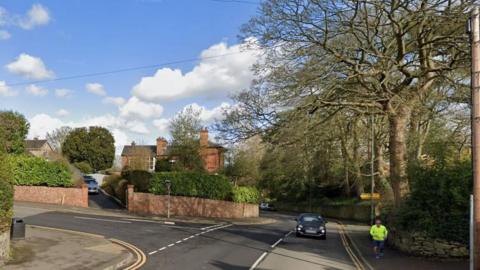 Streetview image of the junction of Hill Street and Kilwardby Street, Ashby-de-la-Zouch, a leafy residential area with a sharp bend