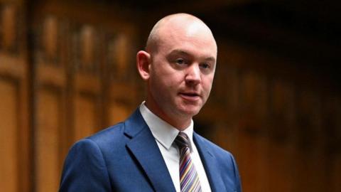 An image of the Fylde MP Andrew Snowden speaking in the House of Commons. He is wearing a blue suit, white shirt and multi-coloured tie.