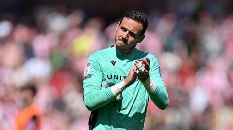 Wrexham goalkeeper Danny Ward applauds