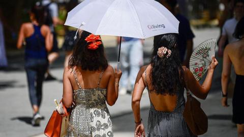 Two people keeping trying to keep cool in Spain