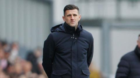John Mousinho on the touchline