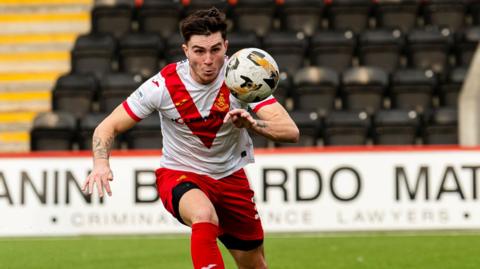 Mason Hancock chases the ball during a game for Scottish Championship club Airdrieonians