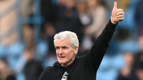 Mark Hughes gives a thumbs up to Carlisle supporters