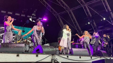 Sister Sledge on stage. Four women and two male backup vocalists