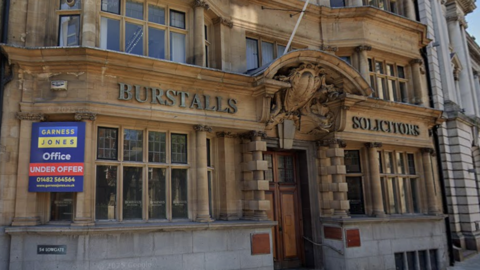 The Grade II listed building on Lowgate in Hull. It is an historic looking building with Burstalls Solicitors in lettering on the front.