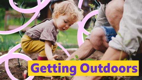 Father and child playing together in garden.