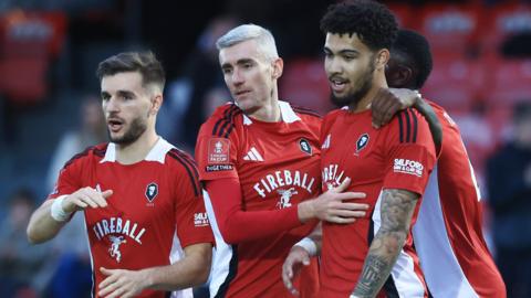 Salford players celebrate a goal against Cheltenham