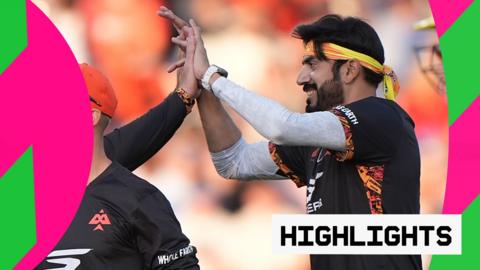 Usman Tariq celebrates taking a wicket with his teammate