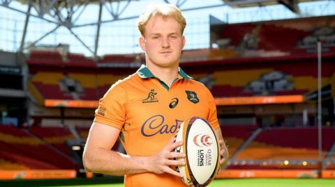Tom Lynagh poses with a rugby ball