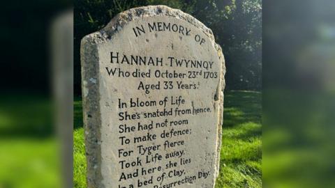 A close-up of the headstone detailing Hannah Twynnoy's date of death and showing a poem which includes the words, "For Tyger fierce Took Life away".