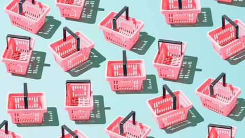 pink shopping baskets on a light blue background