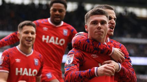 Leif Davis (second right), wearing Ipswich Town's red away strip with blue and white trim, celebrates his goal against Derby County with team-mates