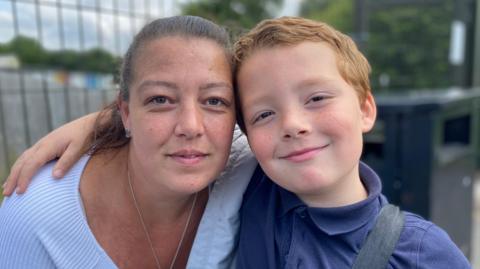 Emma and Jenson pictured outside the school