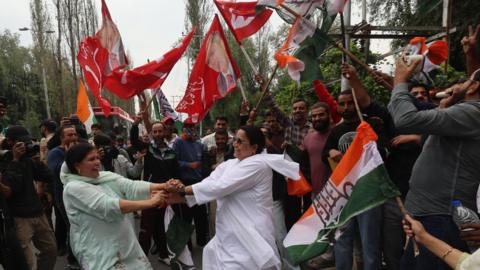 Supporters of Indian Congress party and National Conference celebrate outside a counting centre in Srinagar in Kashmir on 08 October 2024. The Congress-National Conference coalition is leading in state assembly polls