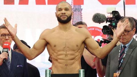 Chris Eubank Jr opens his arms as he weighs in