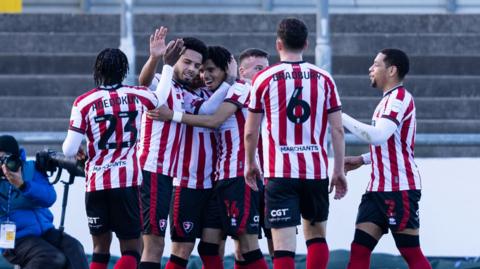 Cheltenham Town players celebrate Matty Taylor's goal