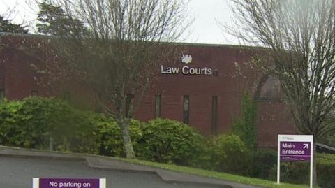 Bodmin Magistrates Court which has the words Law Courts written on the side with a sign next to it saying main entrance.