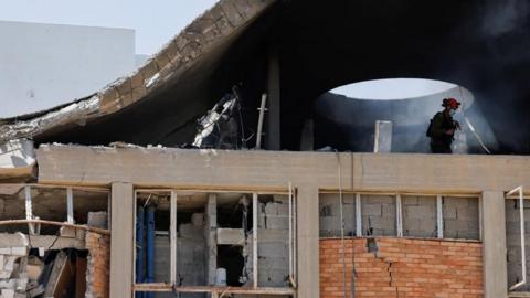 n Emergency worker inspects an impact site, following a missile strike from Iran on Israel, at Soroka Medical Center, in Be'er Sheva