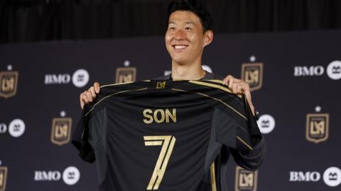 Son Heung-min holds up an LAFC shirt with Son 7 on the back